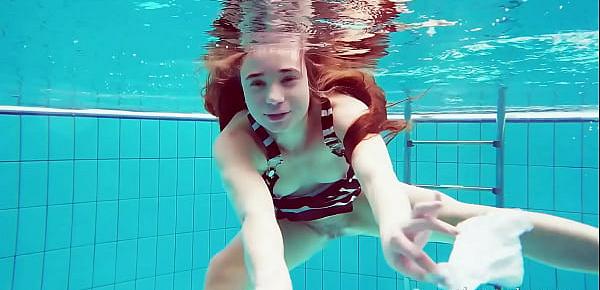  Cute hairy pussy teenie Nina in the swimming pool